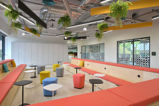 coral sofas, with small tables in an office space