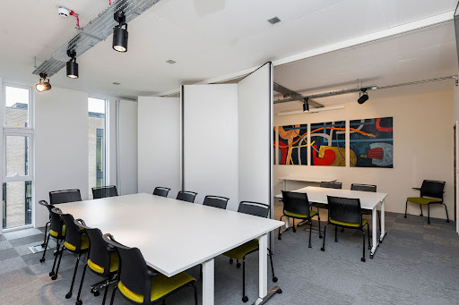 meeting room with a white table and black chairs