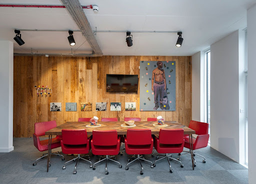 office meeting room with a wooden table and red chairs